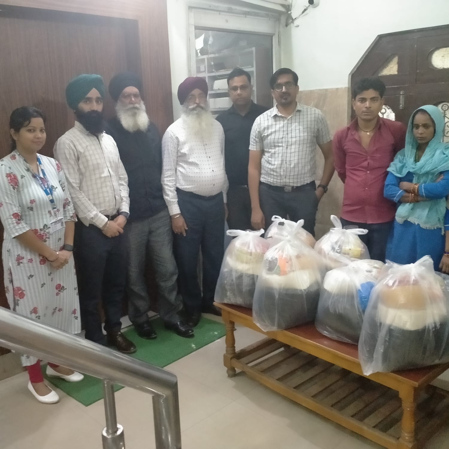 Ration kit distribution to staff whose houses were drowned in flood